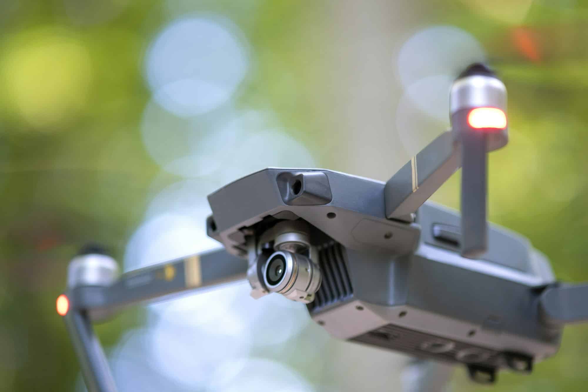 Ferkomedia - Drone copter with blurred propellers and video camera flying in air